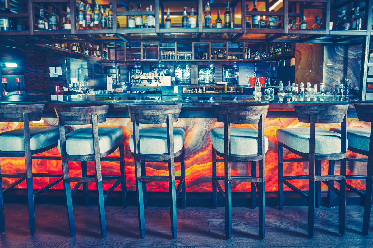 Cafe interior modern design: pub comfort furniture for socializing, speaking, resting, drinking, meeting. Epic bar table place with chairs and desk for business meet, night party. Cinematic light shot